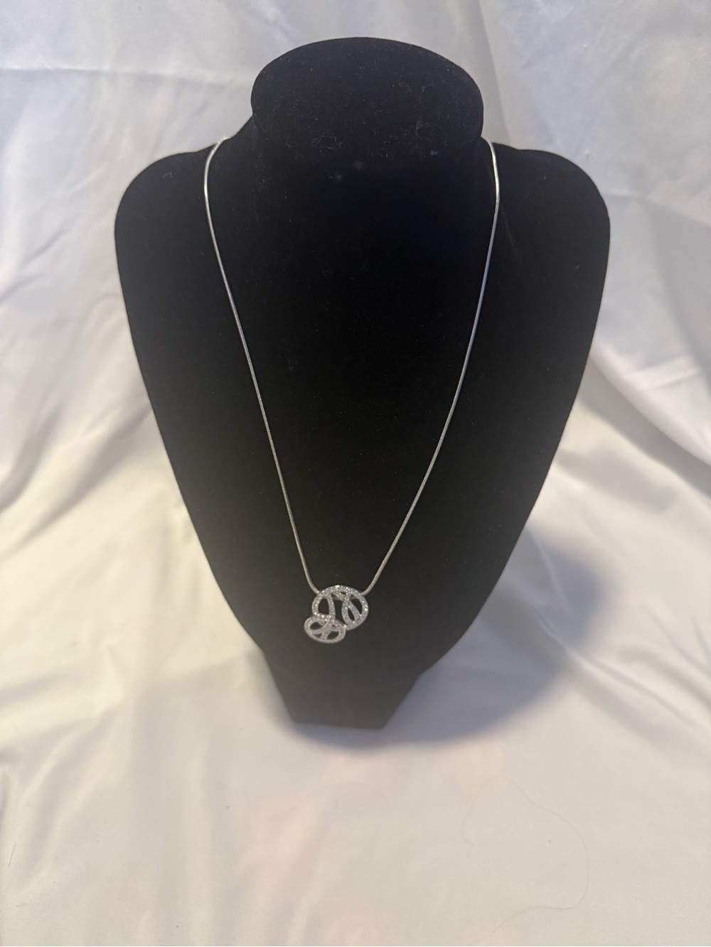 Swarovski pendant w/a distinctive interlocking design with clear pavé crystals